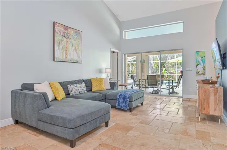 Living area with a high ceiling and stone tile flooring
