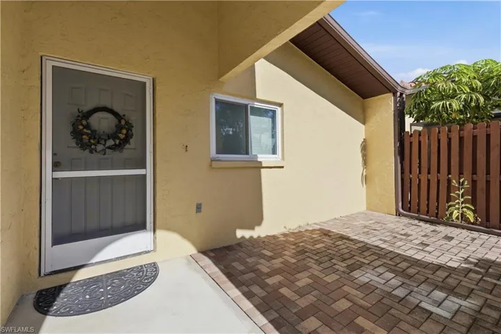 Doorway to property with a patio area and stucco siding