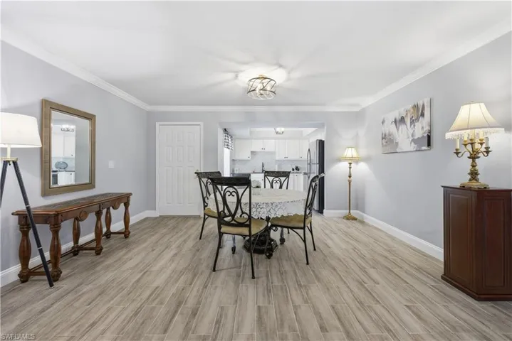 Dining room with wood tiled floors and crown molding