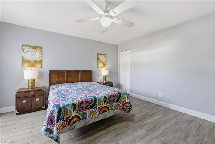 Bedroom featuring wood finish floors, a ceiling fan, and a closet