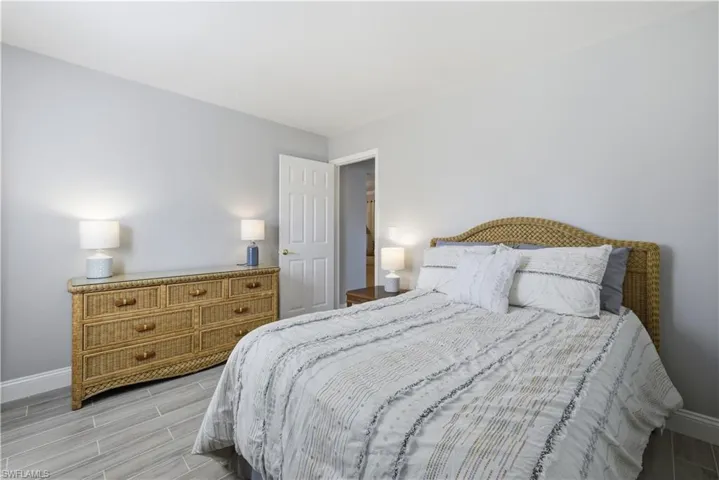 Bedroom with baseboards and wood finish floors