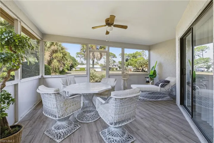Sunroom / solarium with ceiling fan, outdoor dining space, and plenty of natural light