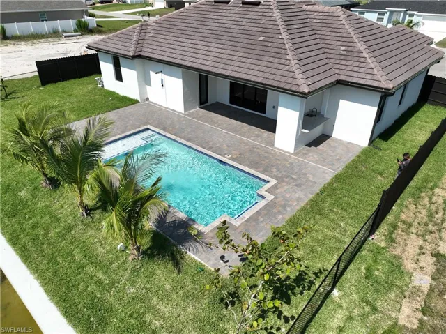 View of swimming pool featuring a lawn and a patio