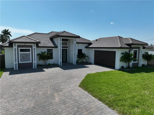View of front of house featuring a garage and a front yard
