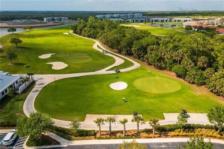 Drone / aerial view of a golf club and a nearby body of water