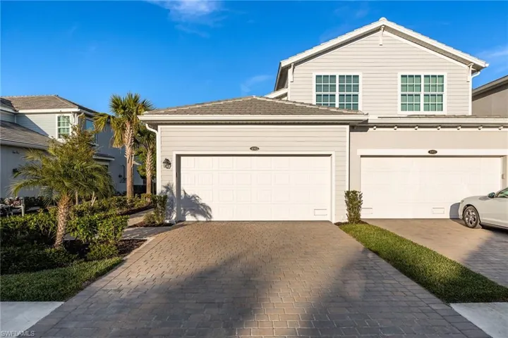 Front of condo with an attached 2-car garage