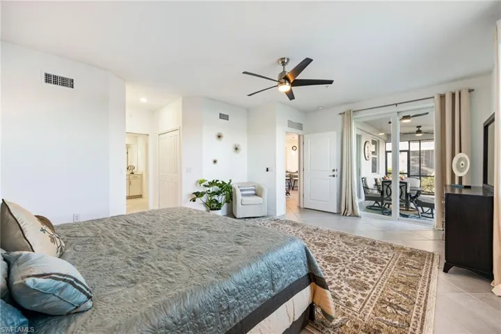 Spacious primary bedroom with sliders to the lanai & an en suite bathroom