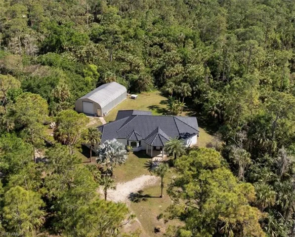 View from above of property with a forest