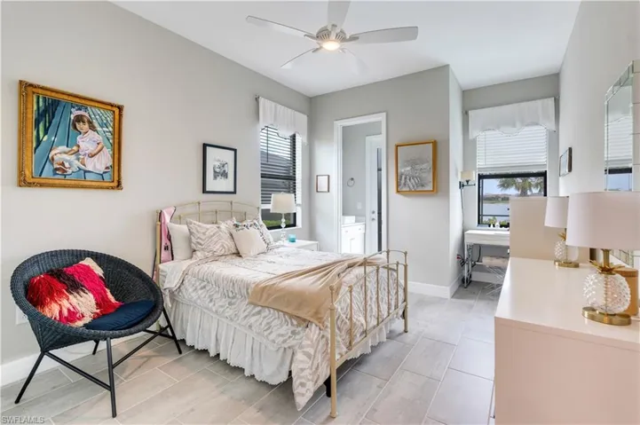 Bedroom featuring ceiling fan and light tile floors