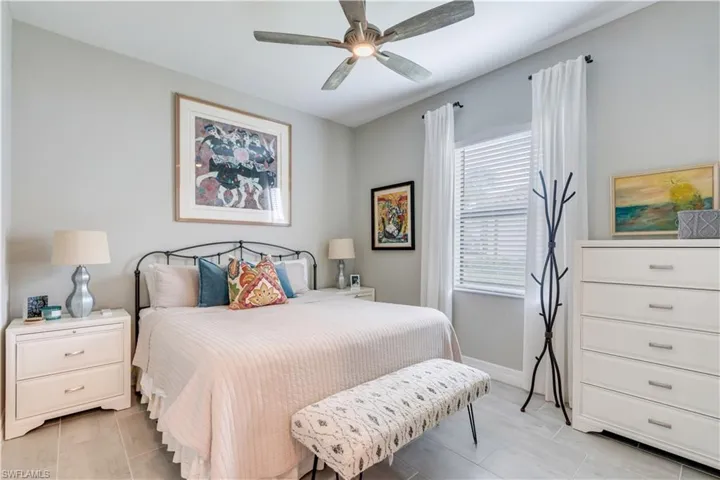 Bedroom featuring ceiling fan and light tile floors