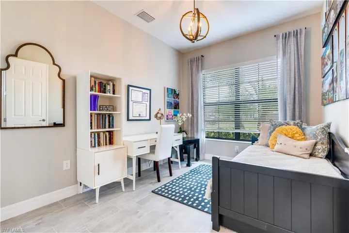 Bedroom with a notable chandelier