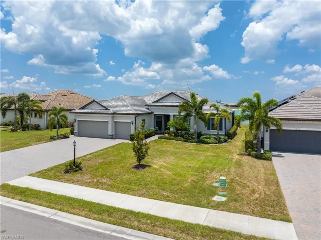 Single story home with a garage and a front yard
