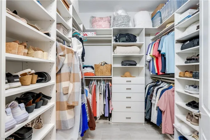 Spacious closet with light tile floors