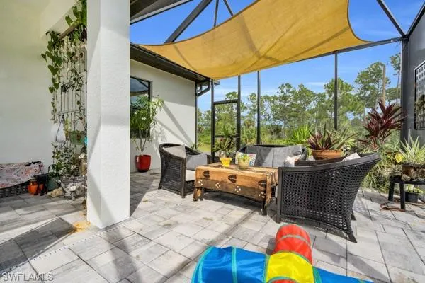 View of patio featuring a sunroom and outdoor lounge area