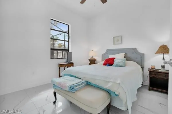 Bedroom featuring marble finish floors and ceiling fan
