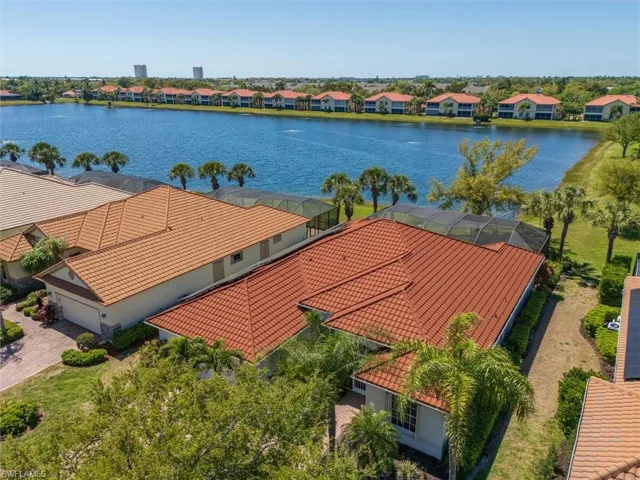 Aerial view of residential area featuring a nearby body of water