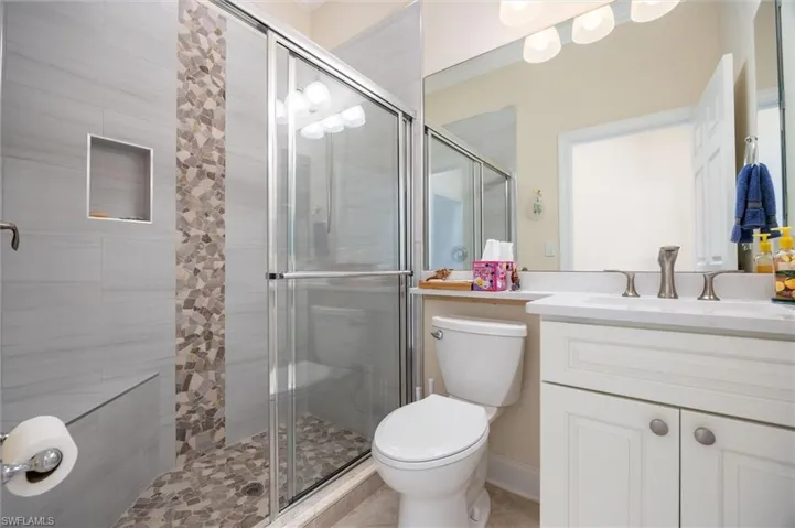 Bathroom with vanity and a stall shower