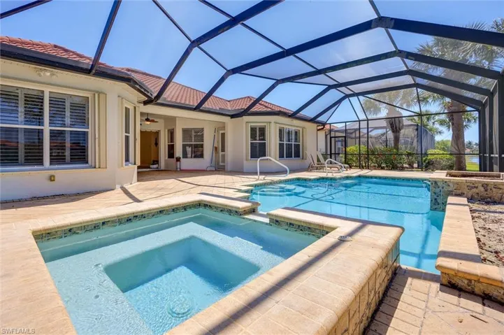 Integrated pool / spa with a sunroom, a patio area, and a lanai