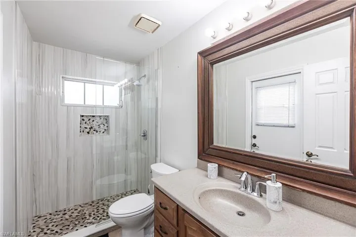 Bathroom featuring vanity and tiled shower