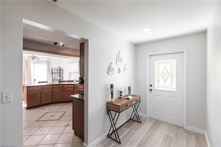 Entryway featuring plenty of natural light, light tile patterned floors, and ceiling fan