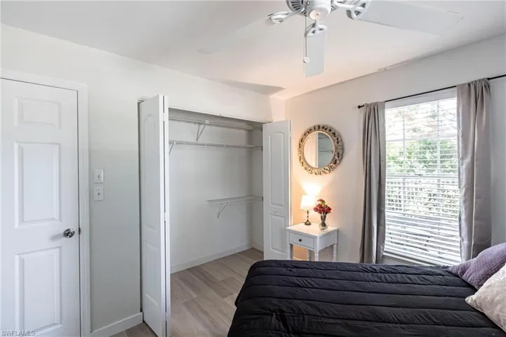 Bedroom with a closet, light wood finished floors, and ceiling fan