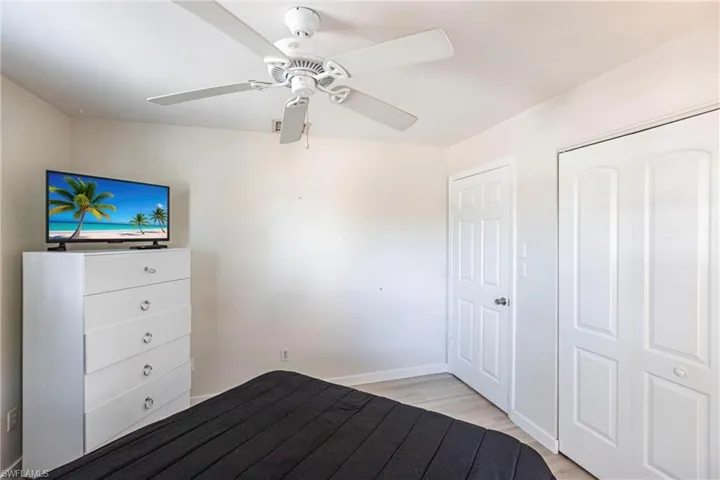 Unfurnished bedroom featuring light wood finished floors, ceiling fan, and a closet