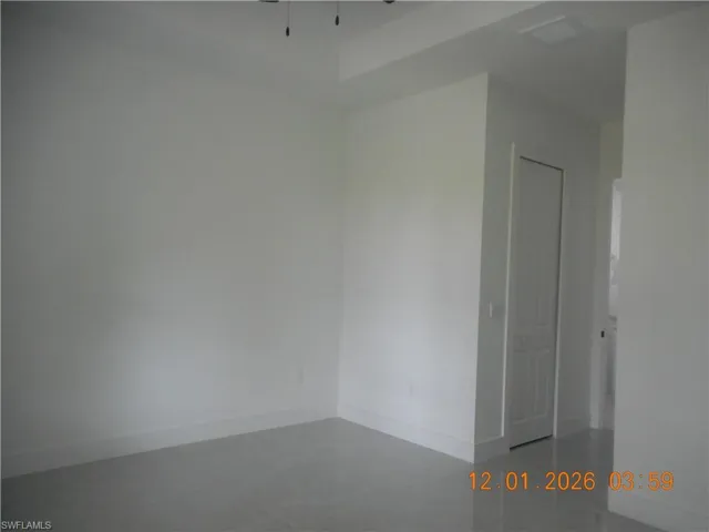 Unfurnished room with baseboards and ceiling fan