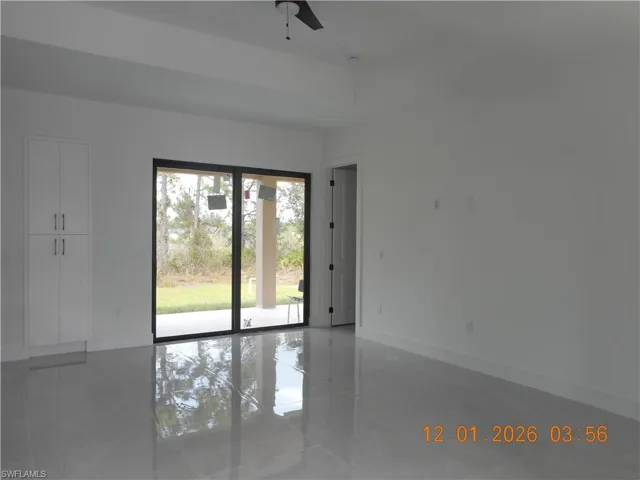 Empty room featuring baseboards and a ceiling fan
