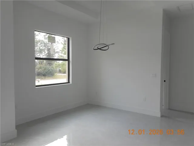 Unfurnished dining area with concrete floors and baseboards