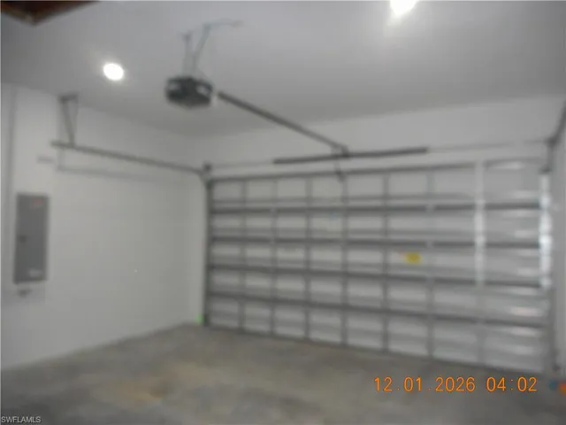 Garage featuring recessed lighting and a garage door opener