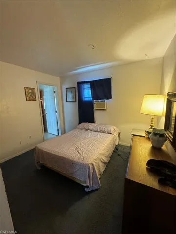 Carpeted bedroom featuring cooling unit