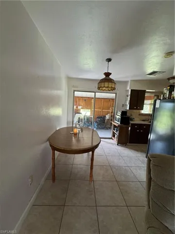 Dining space with light tile patterned floors