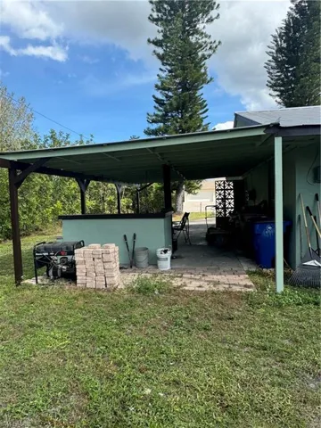 View of vehicle parking featuring a yard