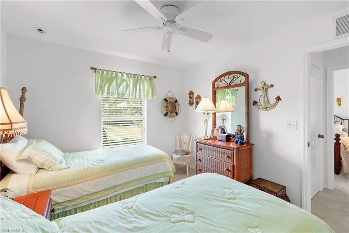 Carpeted bedroom featuring ceiling fan