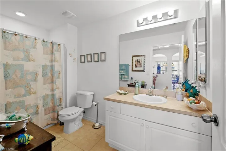 Bathroom with vanity, toilet, and tile floors