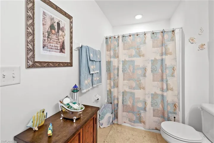 Bathroom featuring toilet and tile floors