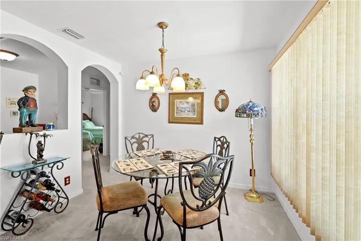 Dining room featuring a notable chandelier and carpet floors