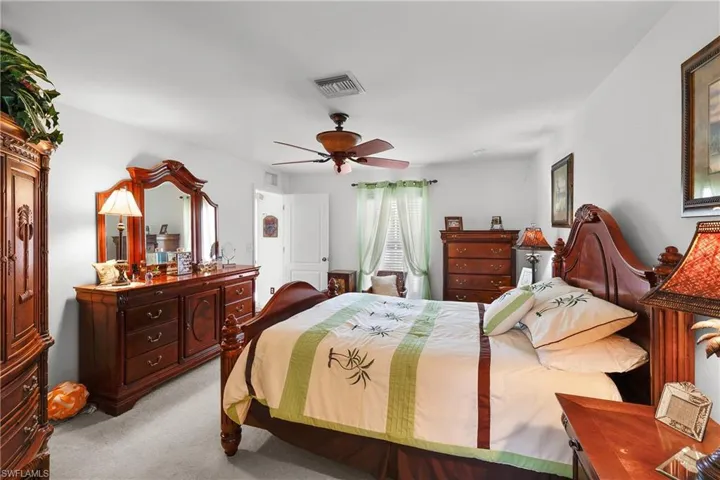 Bedroom featuring ceiling fan and light carpet