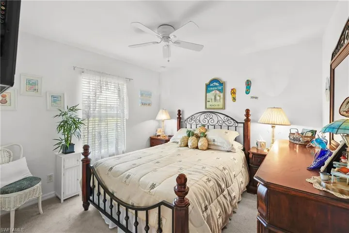 Carpeted bedroom with ceiling fan