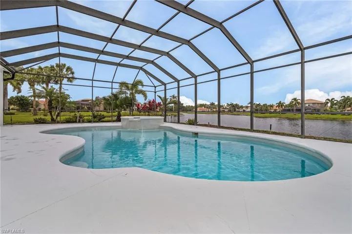View of swimming pool with a patio, a lanai, an in ground hot tub, and a lake view