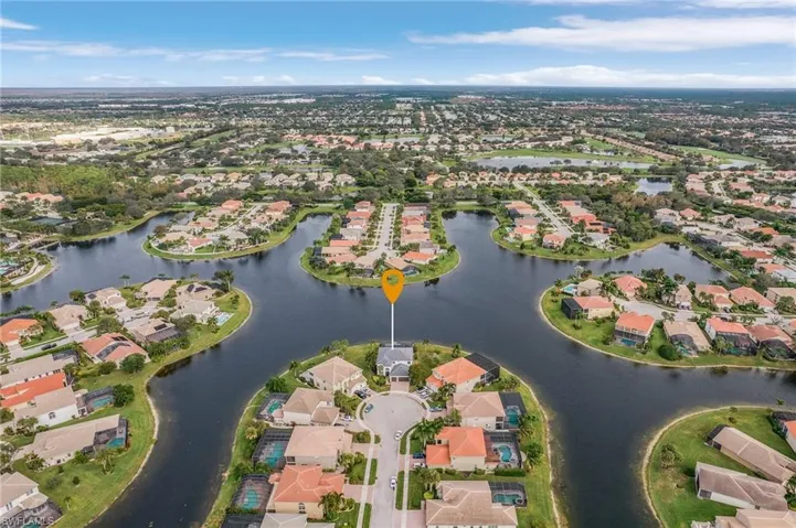 Birds eye view of property with a lake view
