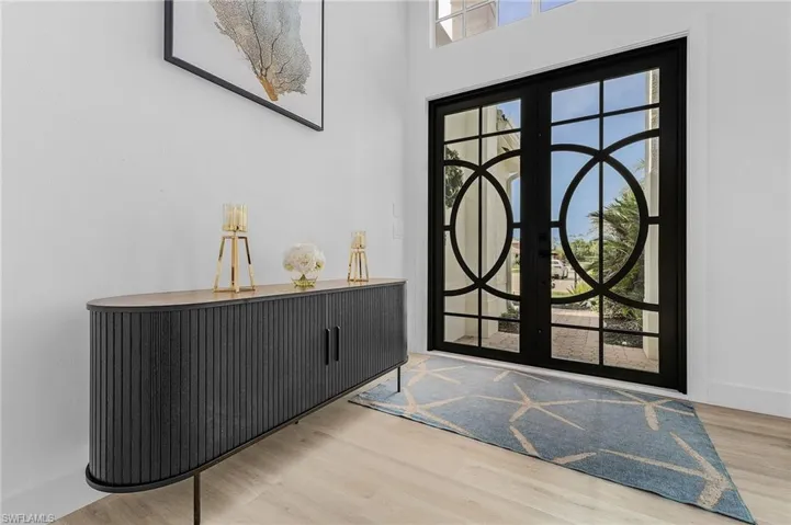 Foyer with hardwood / wood-style flooring and beautiful glass double doors