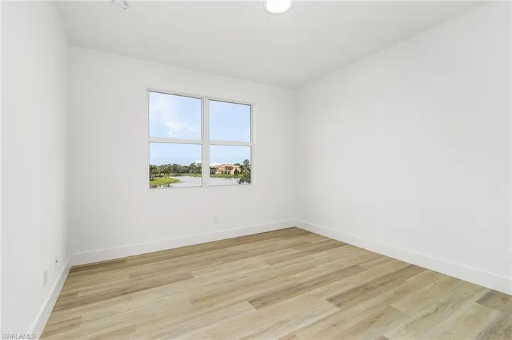 Guest Bedroom featuring light hardwood / wood-style flooring