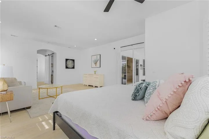 Primary Bedroom with light hardwood / wood-style floors and ceiling fan