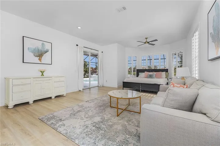 Primary Bedroom with a wealth of natural light, ceiling fan, and light hardwood / wood-style flooring