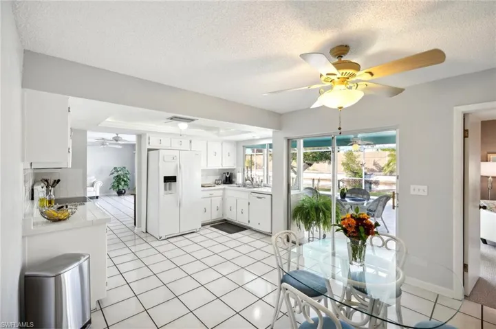 Kitchen & Dining Area with Sliders accesses Covered Lanai Dining and sitting areas