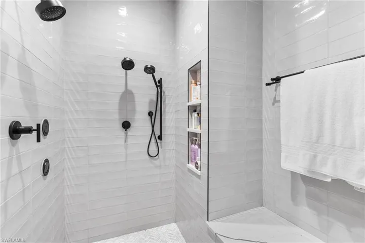 Oversized walk in shower and seating area.
