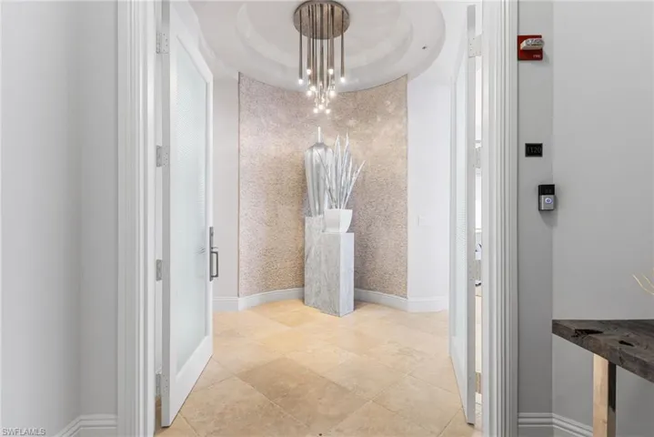 Entry way has a stacked stone wall, spectacular chandelier! 11.5' ceilings throughout!