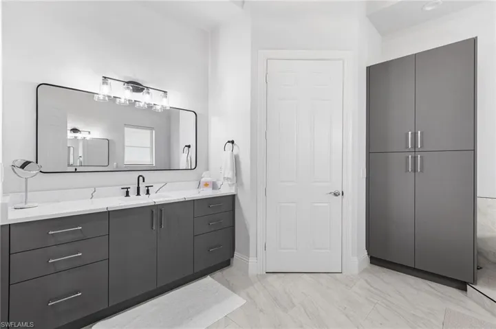 Separate quartz counteop vanities for his and hers space! Private water closet.