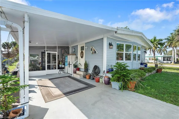 Rear view of property featuring a yard and a patio area